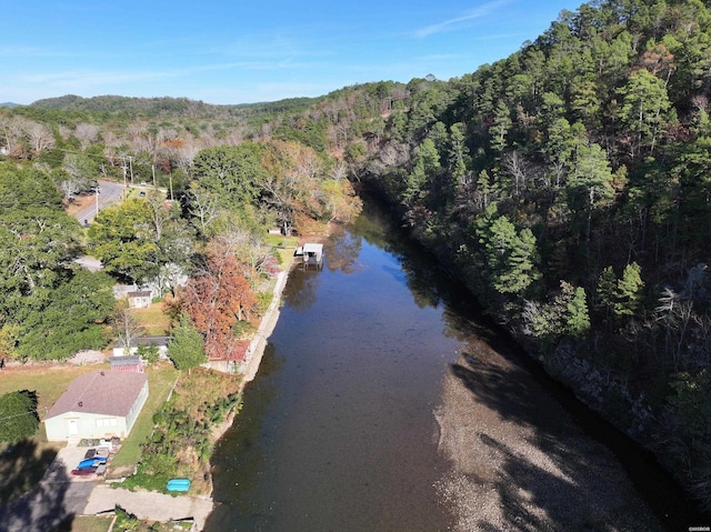 drone / aerial view featuring a wooded view