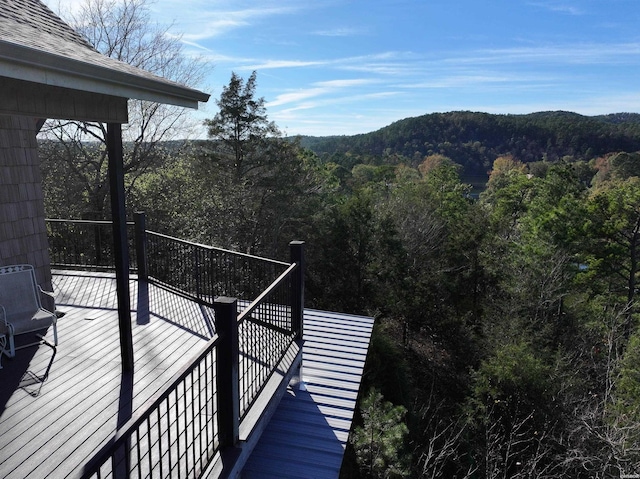 wooden terrace with a wooded view