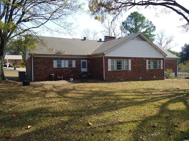 back of house with a yard, brick siding, crawl space, and a shingled roof