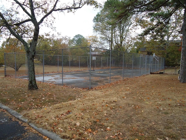 view of tennis court with fence