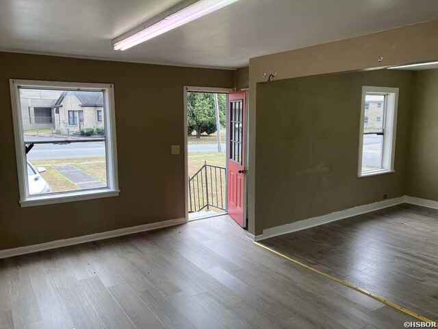 unfurnished room featuring wood finished floors and baseboards