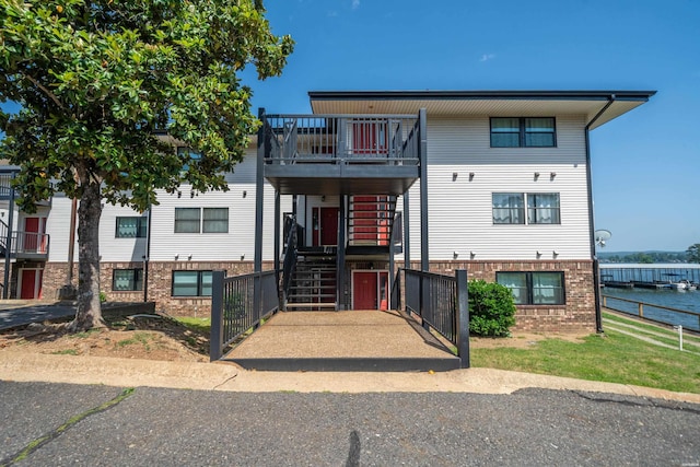 5371 Central Ave Unit 6D, Hot Springs, AR 71913 - view of front of property featuring brick siding, a balcony, fence, stairway, and a water view