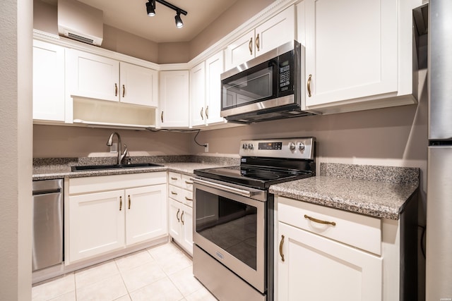 740 Weston Rd Unit 102, Hot Springs, AR 71913 - kitchen featuring a sink, light tile patterned flooring, an AC wall unit, white cabinets, and appliances with stainless steel finishes