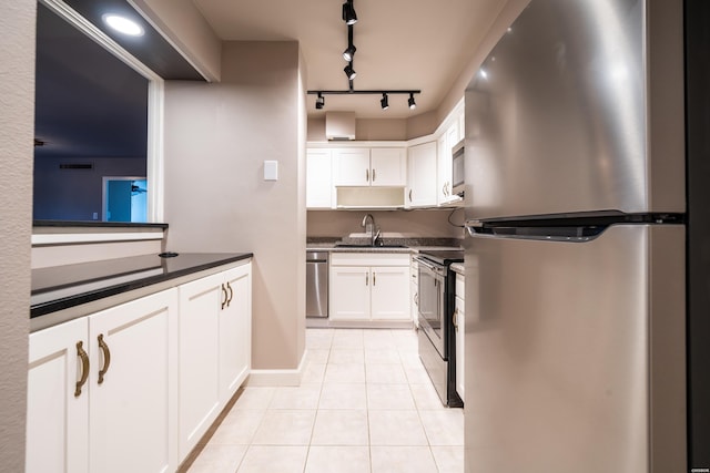 740 Weston Rd Unit 102, Hot Springs, AR 71913 - kitchen featuring a sink, light tile patterned flooring, white cabinets, dark countertops, and appliances with stainless steel finishes