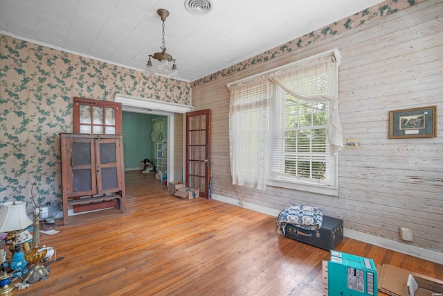 interior space with visible vents, baseboards, and wood finished floors