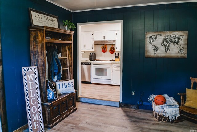 kitchen featuring dishwasher, light countertops, under cabinet range hood, white stove, and white cabinetry