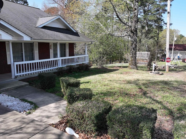 221 Perry St, Glenwood, AR 71943 - view of side of property with a yard, a porch, and roof with shingles