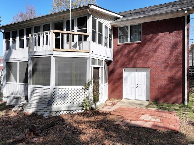 221 Perry St, Glenwood, AR 71943 - rear view of house with a sunroom and brick siding