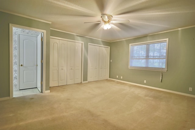 221 Perry St, Glenwood, AR 71943 - unfurnished bedroom with two closets, crown molding, and carpet