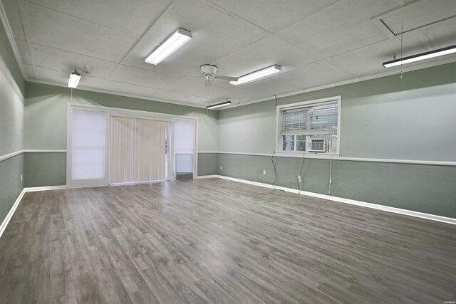 221 Perry St, Glenwood, AR 71943 - spare room with attic access, baseboards, cooling unit, and wood finished floors