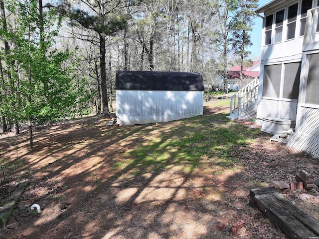 221 Perry St, Glenwood, AR 71943 - view of yard featuring a storage unit and an outdoor structure