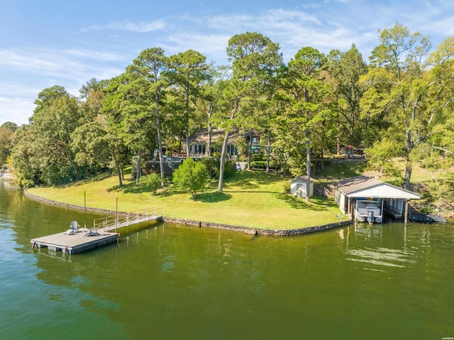 dock area featuring a lawn and a water view