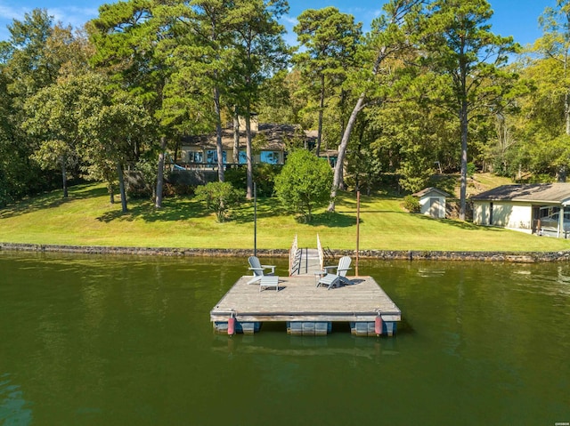 dock area with a water view and a lawn