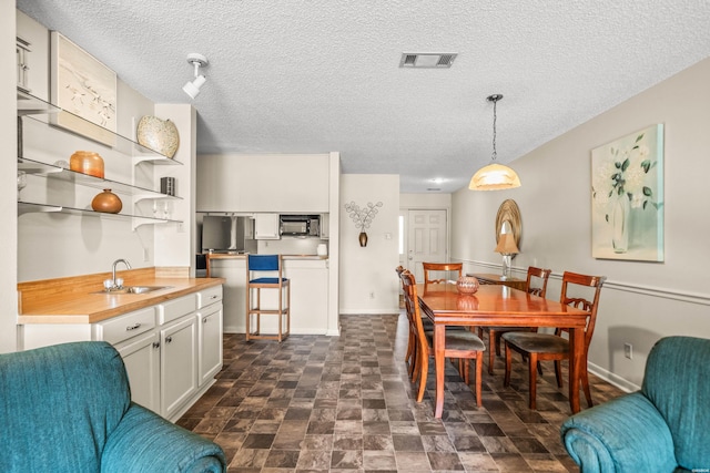 5371 Central Ave Unit 5H, Hot Springs, AR 71913 - dining room featuring a textured ceiling and baseboards