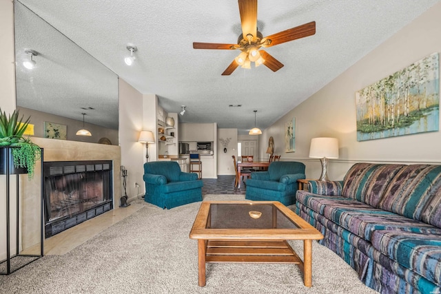 5371 Central Ave Unit 5H, Hot Springs, AR 71913 - living room with a textured ceiling, ceiling fan, carpet, and a fireplace with flush hearth