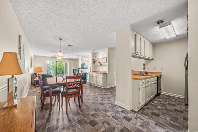 5371 Central Ave Unit 5H, Hot Springs, AR 71913 - dining room with a textured ceiling and baseboards