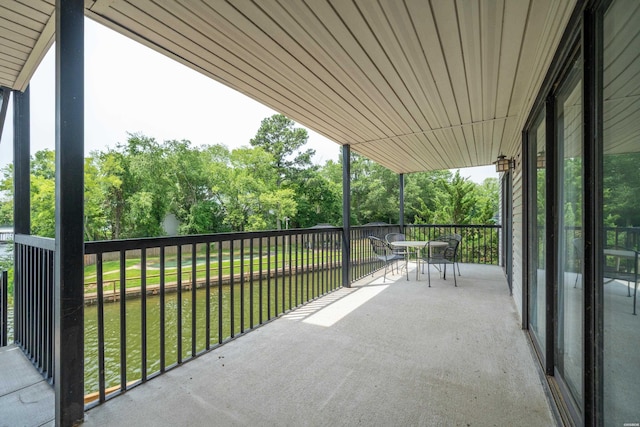 5371 Central Ave Unit 5H, Hot Springs, AR 71913 - balcony with outdoor dining space and view of wooded area