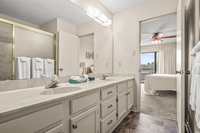 5371 Central Ave Unit 5H, Hot Springs, AR 71913 - full bath featuring a textured ceiling, connected bathroom, double vanity, a ceiling fan, and a shower with door