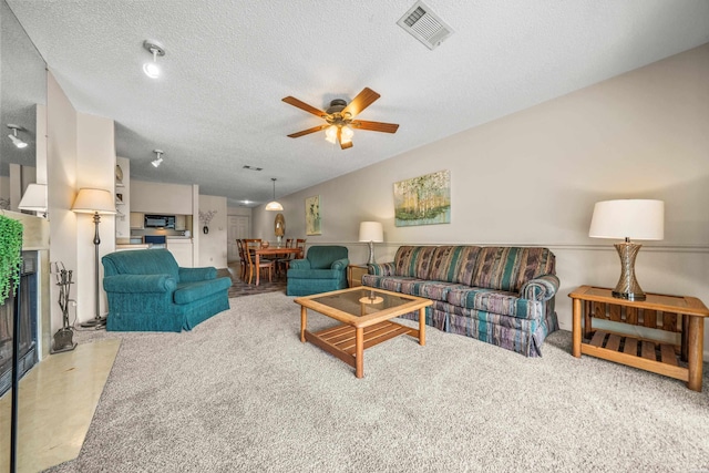 5371 Central Ave Unit 5H, Hot Springs, AR 71913 - carpeted living room with a ceiling fan, a textured ceiling, and a fireplace