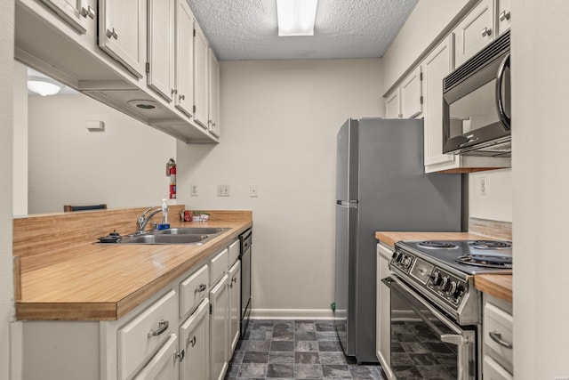 5371 Central Ave Unit 5H, Hot Springs, AR 71913 - kitchen with black microwave, range with electric stovetop, wooden counters, a textured ceiling, and white cabinets