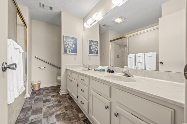 5371 Central Ave Unit 5H, Hot Springs, AR 71913 - full bathroom featuring double vanity, a shower stall, a textured ceiling, and stone finish flooring