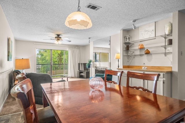 5371 Central Ave Unit 5H, Hot Springs, AR 71913 - dining area with a textured ceiling, a ceiling fan, and bar