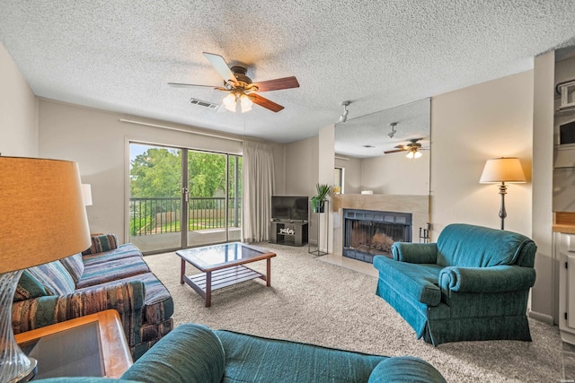 5371 Central Ave Unit 5H, Hot Springs, AR 71913 - carpeted living room featuring ceiling fan, a textured ceiling, and a fireplace with flush hearth