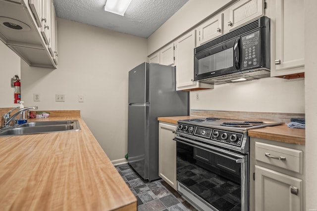 5371 Central Ave Unit 5H, Hot Springs, AR 71913 - kitchen with range with electric stovetop, wood counters, black microwave, a textured ceiling, and freestanding refrigerator
