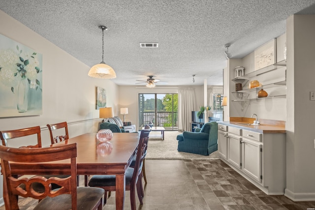 5371 Central Ave Unit 5H, Hot Springs, AR 71913 - dining area with a textured ceiling and a ceiling fan