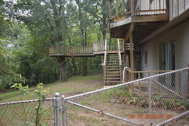 view of yard with a fenced backyard, stairway, and a wooden deck