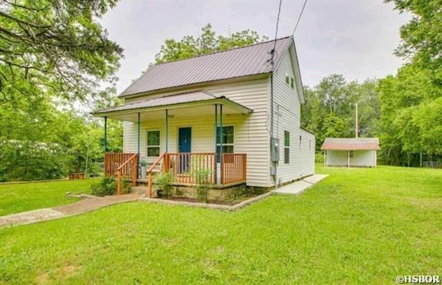 view of front of property featuring metal roof, a porch, and a front yard