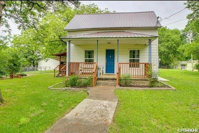 bungalow-style house with metal roof, a front lawn, and a porch