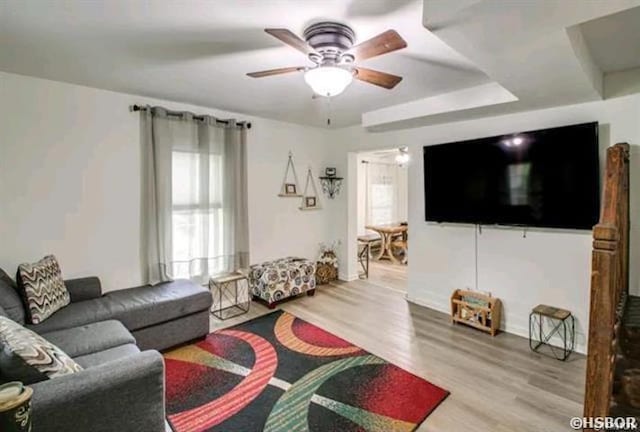 living area featuring a ceiling fan and wood finished floors