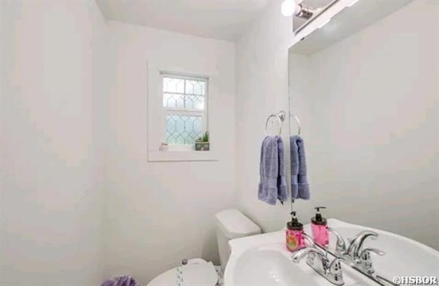 bathroom featuring toilet and a sink