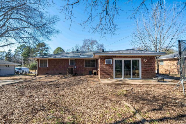 back of property featuring crawl space, a patio area, brick siding, and central AC unit