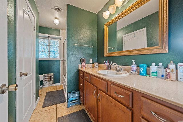 full bathroom featuring enclosed tub / shower combo, tile patterned flooring, visible vents, vanity, and heating unit