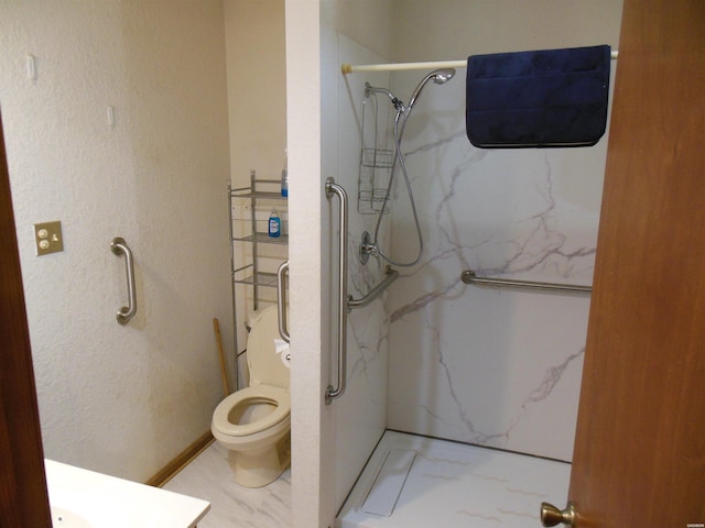 bathroom featuring toilet, marble finish floor, a marble finish shower, and a textured wall