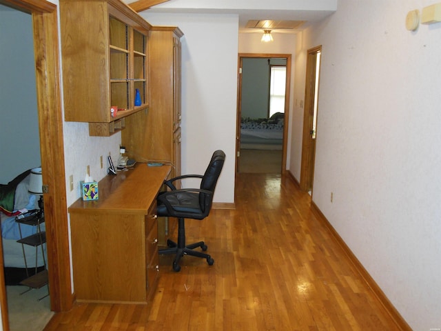 office space with baseboards and wood finished floors