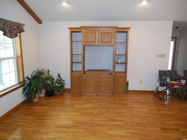 living room with light wood-style flooring and baseboards