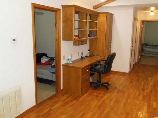 office area featuring light wood-style floors, visible vents, and baseboards