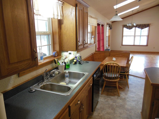 kitchen featuring black dishwasher, brown cabinets, lofted ceiling, dark countertops, and a sink