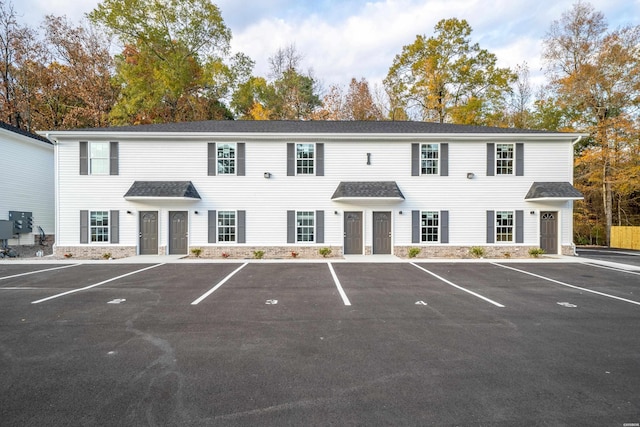 view of building exterior with uncovered parking