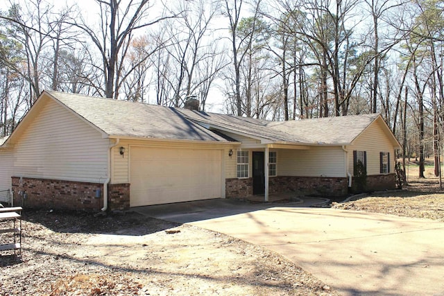 single story home with a garage, driveway, brick siding, and a chimney