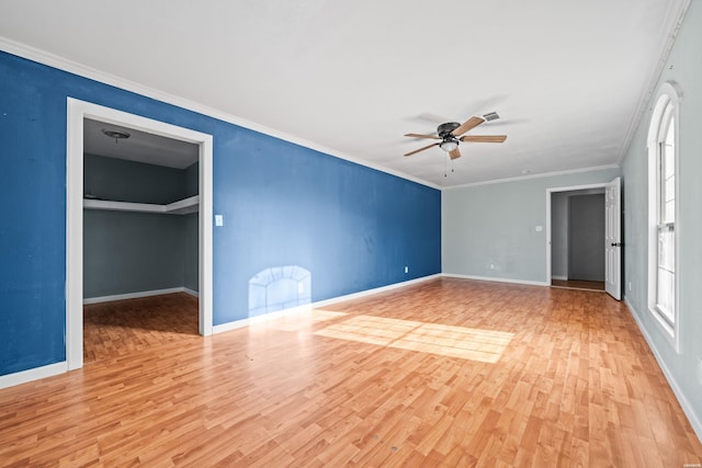 unfurnished room featuring visible vents, baseboards, ceiling fan, ornamental molding, and wood finished floors