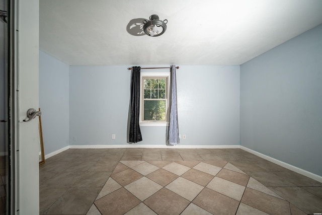 bonus room featuring baseboards and tile patterned flooring