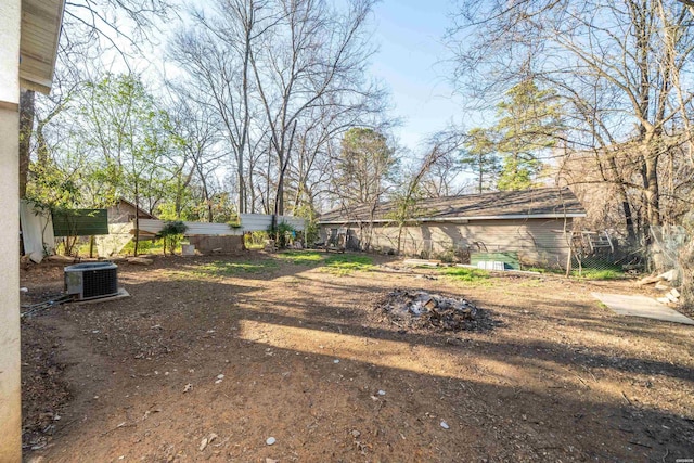 view of yard with cooling unit and fence