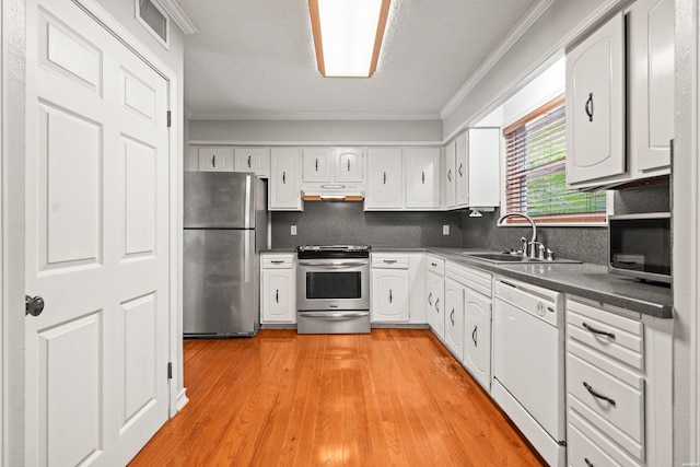 201 Audubon St Unit 1003, Hot Springs, AR 71913 - kitchen featuring stainless steel appliances, ornamental molding, under cabinet range hood, dark countertops, and white cabinets
