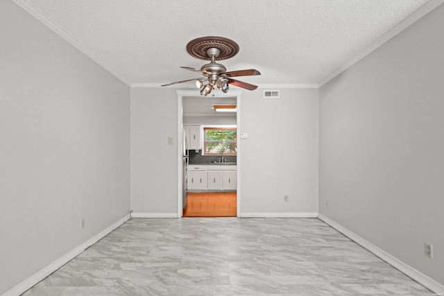 201 Audubon St Unit 1003, Hot Springs, AR 71913 - unfurnished room featuring a textured ceiling, ceiling fan, crown molding, a sink, and light marble finish floors