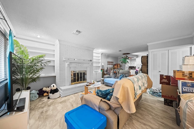 201 Audubon St Unit 1003, Hot Springs, AR 71913 - living area featuring crown molding, a textured ceiling, a brick fireplace, and wood finished floors