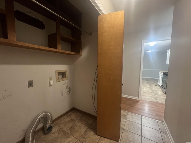 22 Irish Rose Cir, Alexander, AR 72002 - washroom featuring electric dryer hookup, hookup for a washing machine, light tile patterned flooring, and baseboards